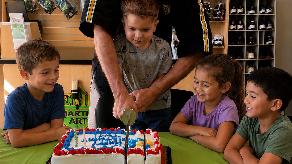 A Premier Martial Arts instructor helping a birthday child cut their cake with a real samurai sword while friends cheer